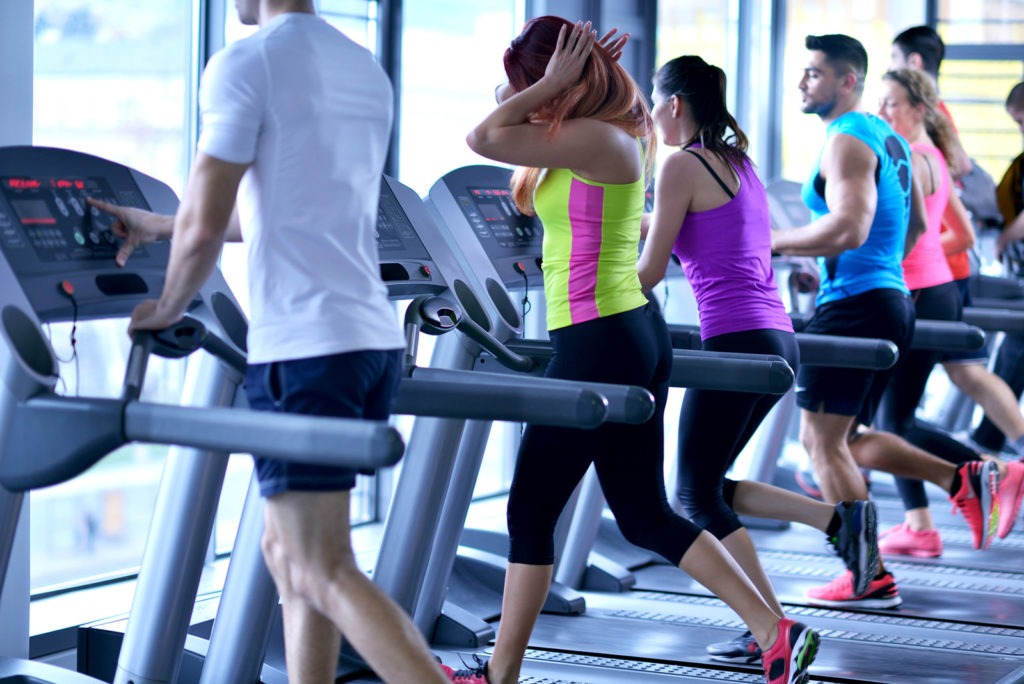 Group of people on treadmills in a gym